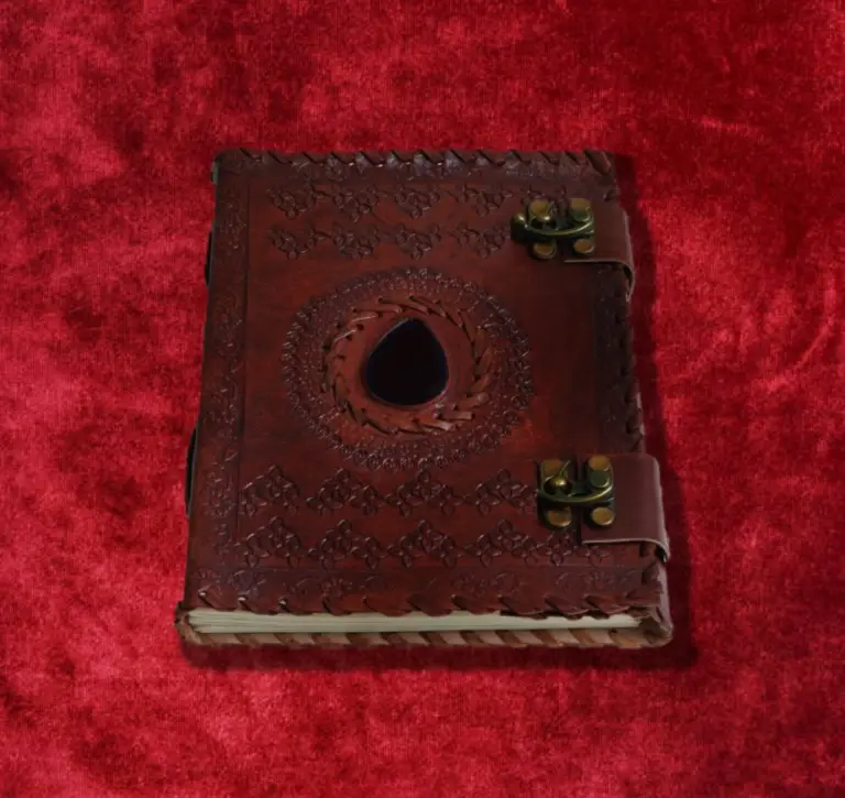 Old book with metal clasps on red cloth